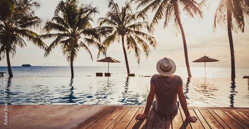 people in luxury beach hotel with luxurious swimming pool at sunset, tropical holidays vacation, tourism and travel background banner © Song_about_summer