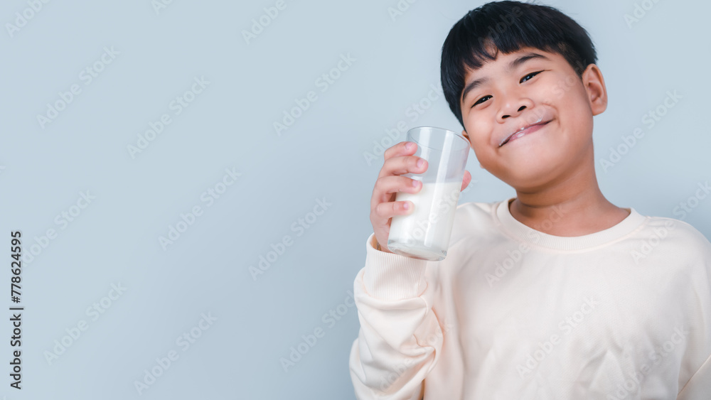 Concept of happy good nutrition, Portrait of a little young handsome kid boy in cream color shirt, Hold drinking milk box mockup, Isolated on white background. Concept of happy good nutrition, Portrait of a little young handsome kid boy in cream color shirt, Hold drinking milk box mockup, Isolated on white background.