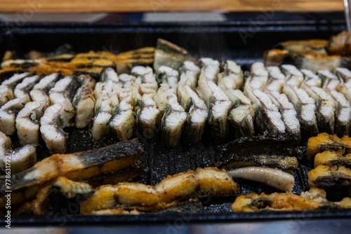Delicious and healthy grilled eel cooked on an iron plate until yellow.
