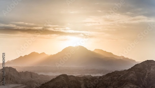 epic sunset landscape sky with big bright sun going behind the mountains in egypt photo