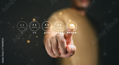 Customer service evaluation concept. Business people are touching the virtual screen on the happy Smiley face icon to give satisfaction in.service. rating very impressed.