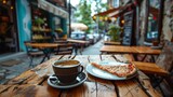 Cup of coffee and slices of pizza on wooden table at outdoor cafe 