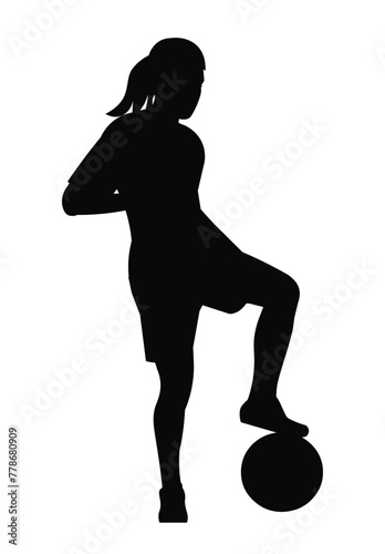Black silhouette of a young girl standing in a half-turn placing her foot on the ball on junior women's football training or female championship