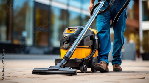 Man using modern vacuum cleaner for construction cleaning closeup shot.