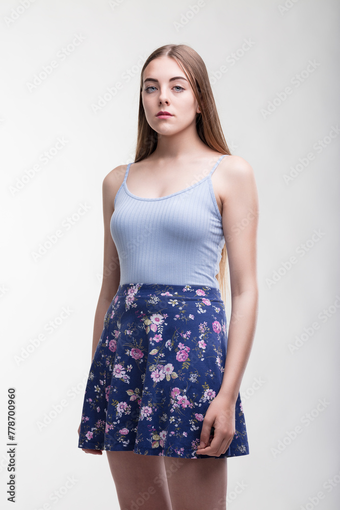 Fashionable attire, neutral backdrop, youthfully poised Fashionable attire, neutral backdrop, youthfully poised