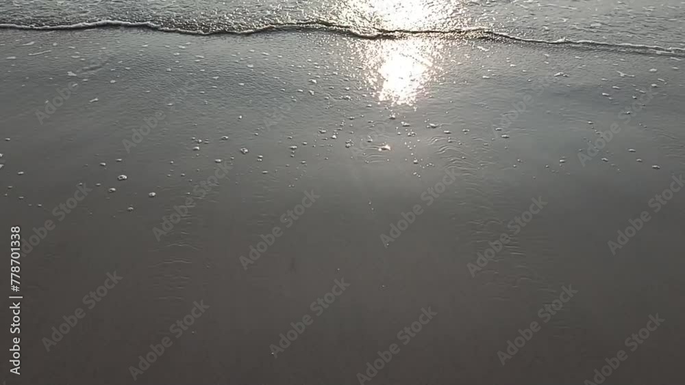 sunrise sunset reflection on ocean wave on sand beach seashore seaside. Summer holiday vacation travel at sea sunrise sunset reflection on ocean wave on sand beach seashore seaside. Summer holiday vacation travel at sea