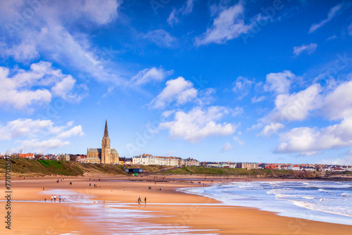 Tynemouth, Tyne and Wear, UK - People take a walk on the beach at Tynemouth on a bright spring day.