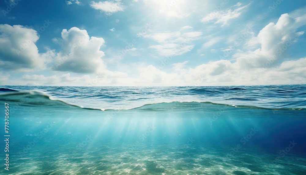 Blue sea or ocean water surface and underwater with sunny and cloudy sky