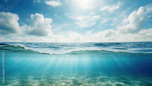 Blue sea or ocean water surface and underwater with sunny and cloudy sky © Marko