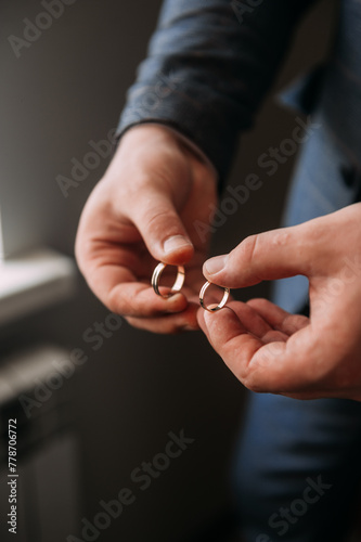 The image is of a pair of hands holding a wedding ring 6992.