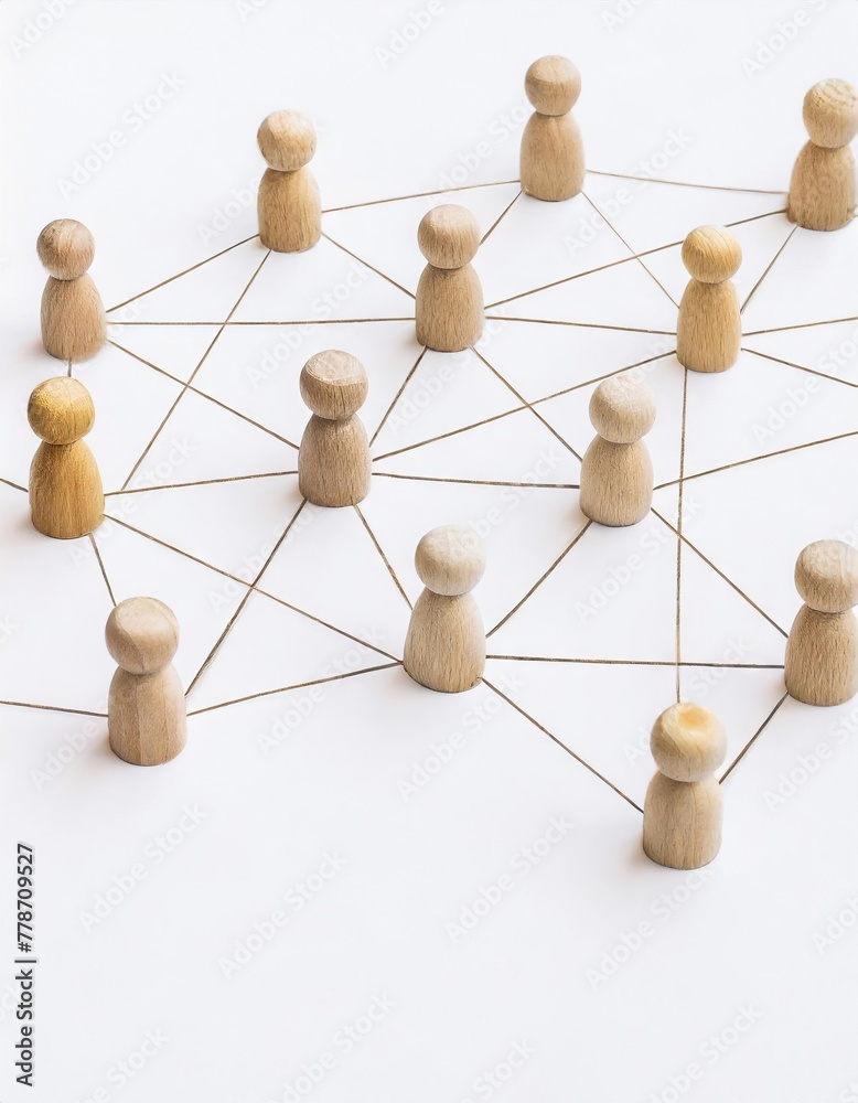 Obraz premium A group of wooden people are connected by strings, forming a network. Concept of interconnectedness and collaboration, as the people are all linked together 