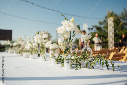 Beautiful flowers decorated on the table. Tables set for an event party or wedding reception.