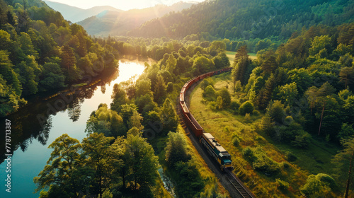 A train travels along the tracks surrounded by dense green foliage in a lush forest photo