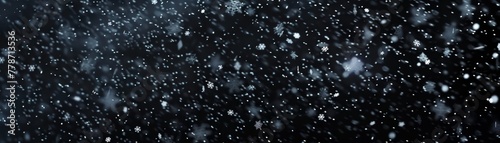 Snowflakes falling down on black background