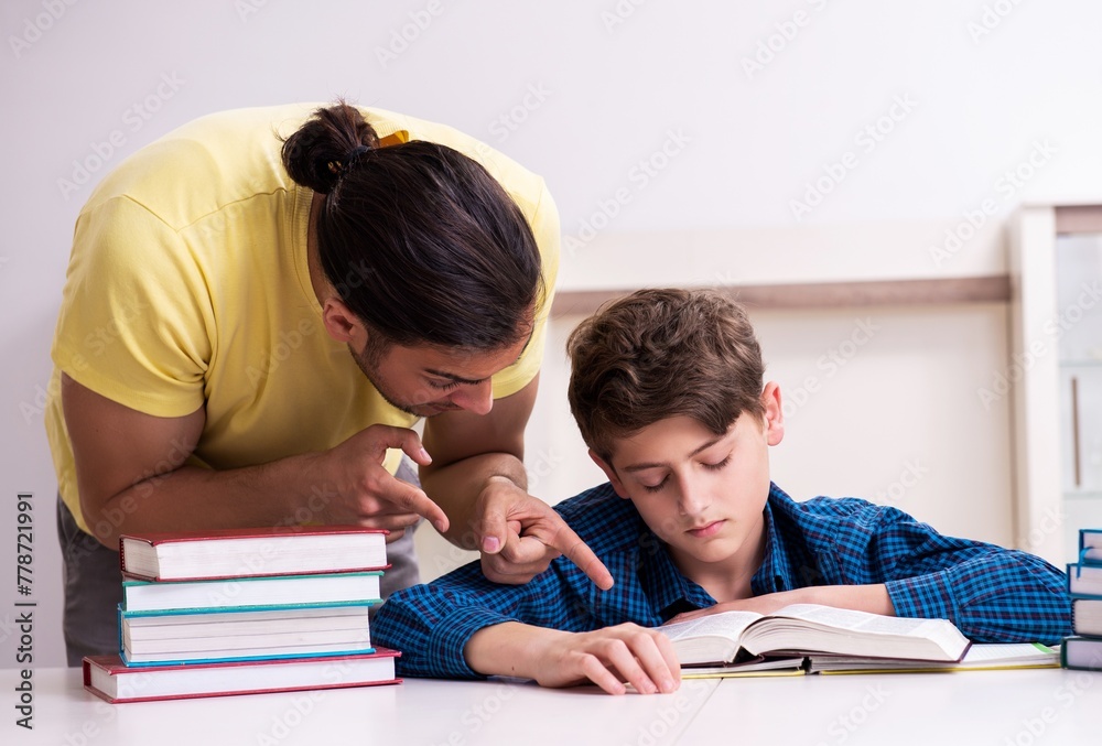 Father helping his son to prepare for school Father helping his son to prepare for school