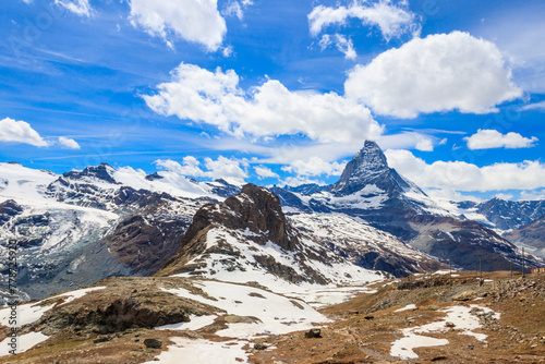 Scenic view on snowy Matterhorn mountain peak in sunny day with blue sky in Switzerland. Beautiful nature background of Swiss Alps covered with snow. Famous travel destination © olyasolodenko