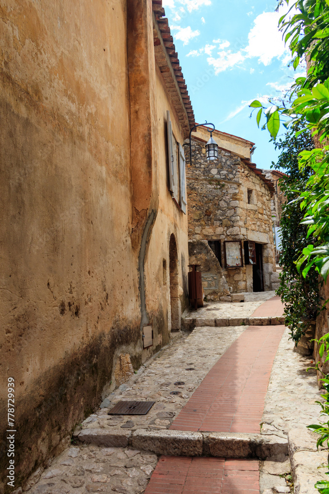 Narrow street in medieval Eze village in French Riviera, France