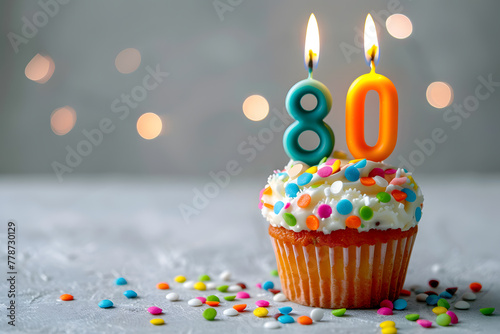 Birthday cupcake with number eighty candle photo