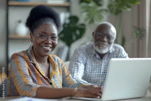 smiling african american female business CEO sitting at desk with laptop and senior male together looking happy while working on financial data, meeting in modern office. generative AI