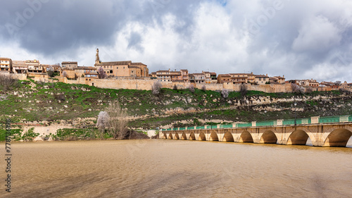 An old village located in a ravine next to the lake that is crossed by a stone bridge, Maderuelo, Spain.