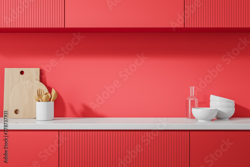 Red home kitchen interior with kitchenware on counter and shelves