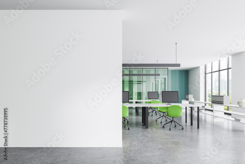 Office coworking interior with pc computers in row and window. Mockup wall