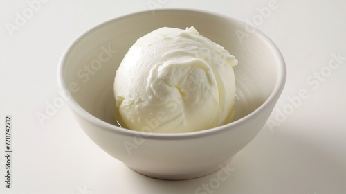 White ball of mozzarella cheese on white background. Smooth surface with light reflection. Design for delicate creamy ravioli filling, purity and freshness concept. 