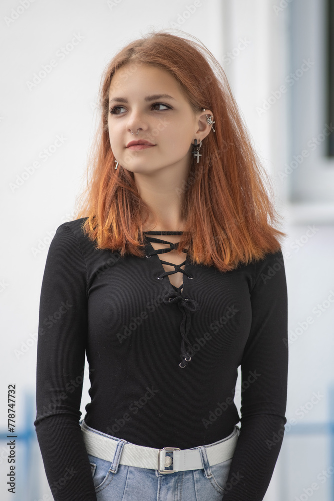 Portrait of a young beautiful red-haired girl in a summer park. Portrait of a young beautiful red-haired girl in a summer park.