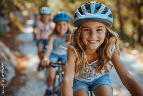 Children ride bicycles together in the park, wearing helmets for protection, enjoying the joy of cycling.