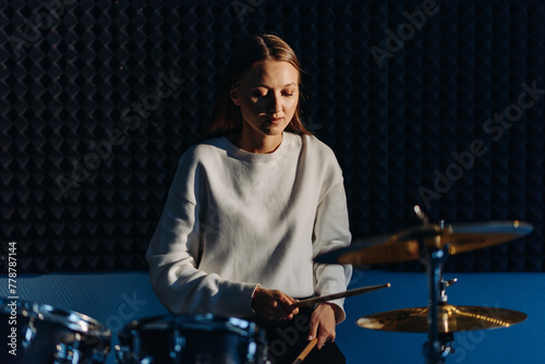 young woman playing drum set
