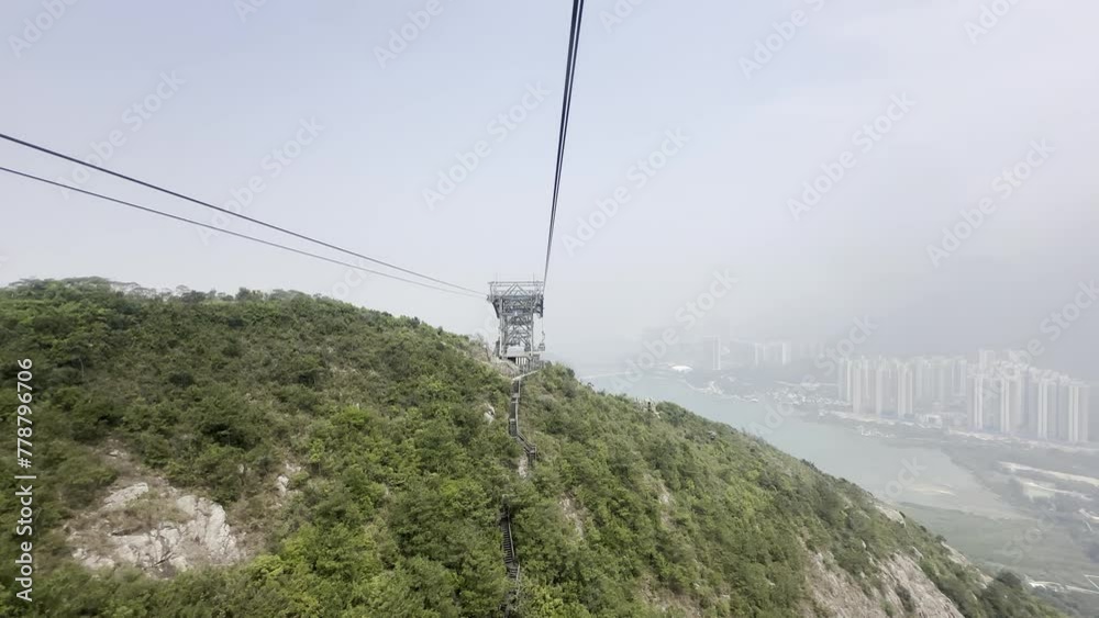 Ngong Ping 360 connects Tung Chung and Lantau Island with the longest cable-stayed cable car system Visitors can enjoy superb sea and mountain views blue sea and the city of Hong Kong in the distance Ngong Ping 360 connects Tung Chung and Lantau Island with the longest cable-stayed cable car system Visitors can enjoy superb sea and mountain views blue sea and the city of Hong Kong in the distance