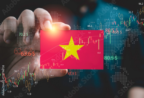 Businessman holding Vietnam flag with stock market graph chat and for Vietnam country is new born economy and high business development growth from many investment concept.