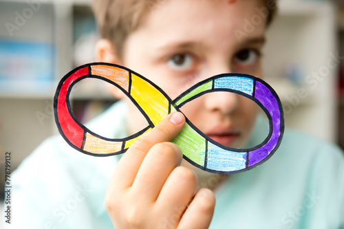 Autism infinity rainbow symbol sign in kid hand. World autism awareness day, autism rights movement, neurodiversity, autistic acceptance movement
