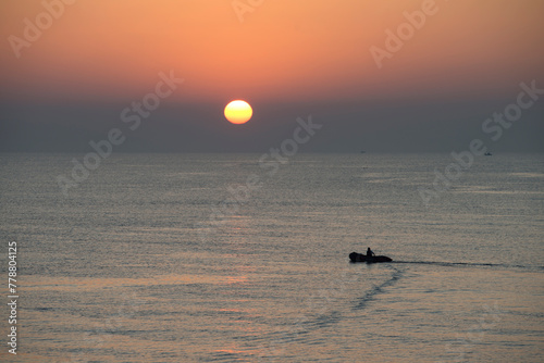 View of the sunrise with the boat on the sea