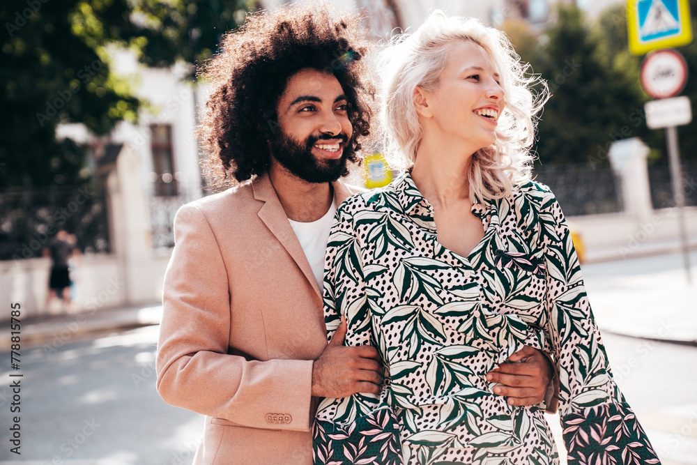 Beautiful fashion woman and her handsome elegant boyfriend in beige suit. Sexy blond model in summer suit clothes. Fashionable smiling couple posing in street Europe. Brutal man and female outdoors