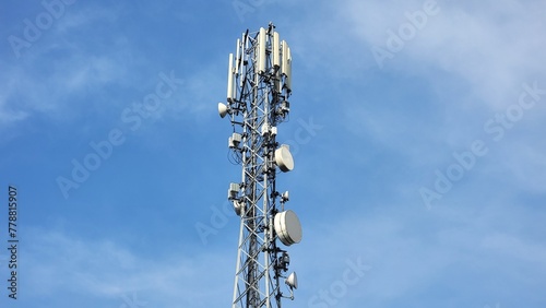 Cell phone telecommunication tower. Communication tower antenna on blue background. Antennas of mobile phone communication, television, internet, radio, on blue sky background. Beautiful 4K Footage.