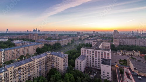 Residential buildings on Leninskiy avenue, Stalin skyscrapers and panorama of city before sunrise. Night to day transition timelapse in Moscow, Russia. Traffic on the road. Aerial view from rooftop photo