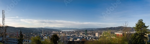 Large panorama of the city of Zurich in spring with the snowy Swiss Alps in the background from the Waid © Ben T.