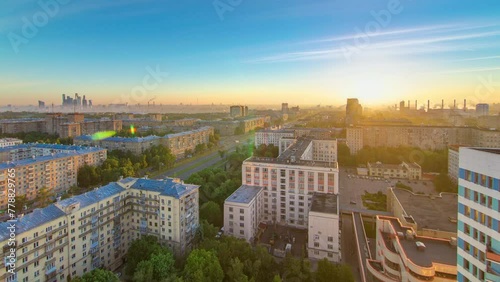 Residential buildings on Leninskiy avenue, Stalin skyscrapers and panorama of the city at sunrise timelapse in Moscow, Russia. Traffic on the road. Aerial view from rooftop photo