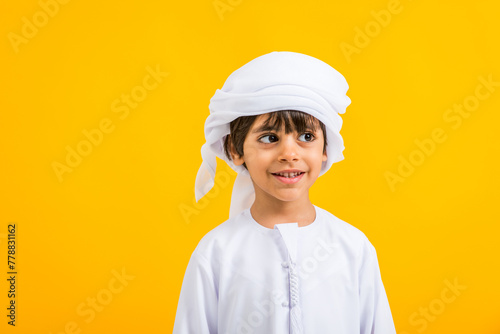 Portrait of middle eastern cute kid wearing traditional emirate clothing