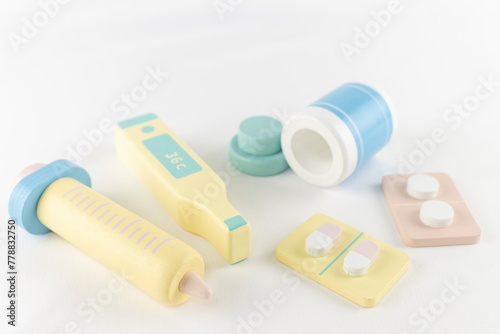 玩具の注射器と体温計と医薬品。医療のイメージ