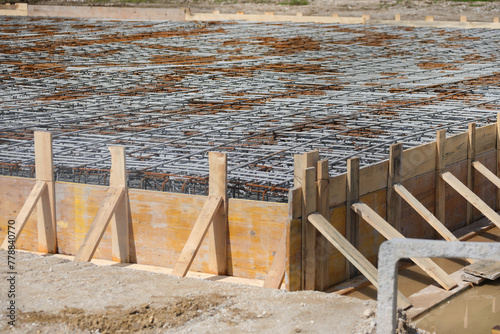 construction of building foundation with reinforced concrete pouring on construction site photo