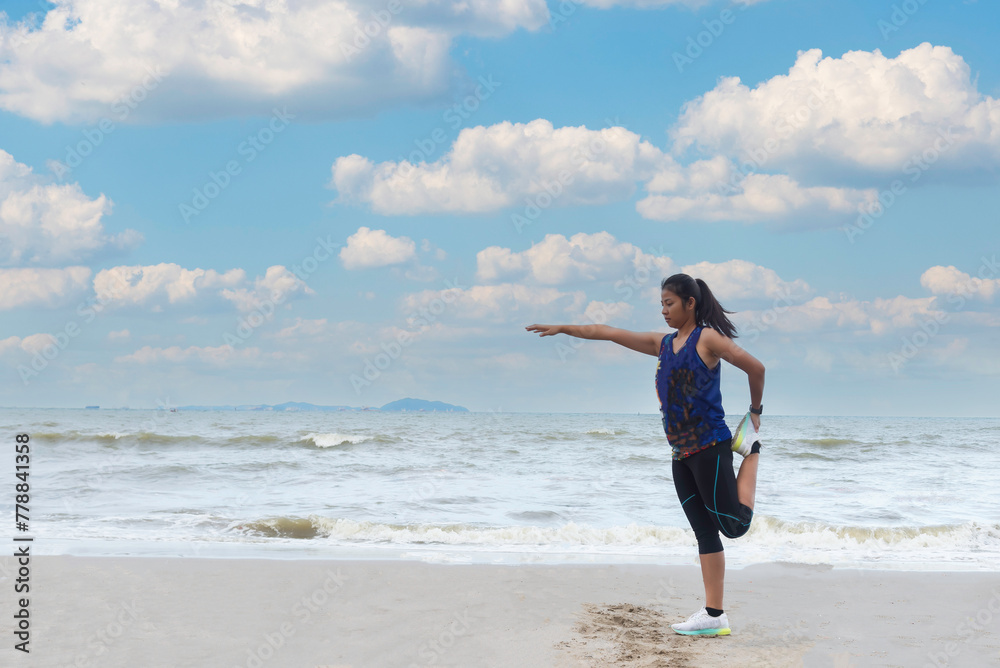 Athletic woman jogging exercise and relax and freedom on sand beach.Lifestyle and Healthy Concept.