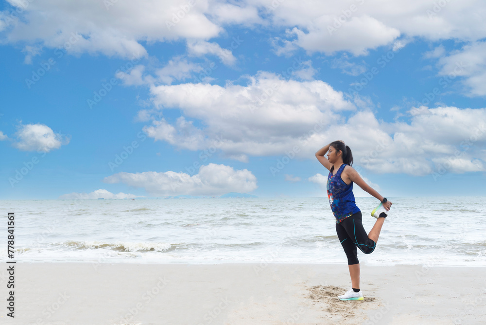 Athletic woman jogging exercise and relax and freedom on sand beach.Lifestyle and Healthy Concept.