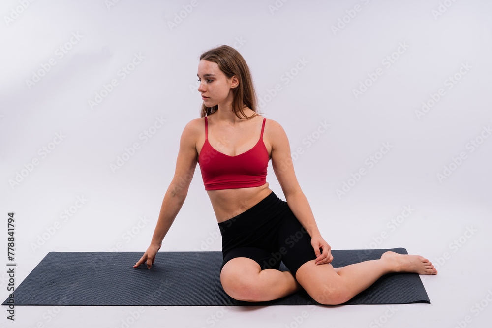 Beautiful female in yoga studio. A woman doing a yoga. Lady in a top.