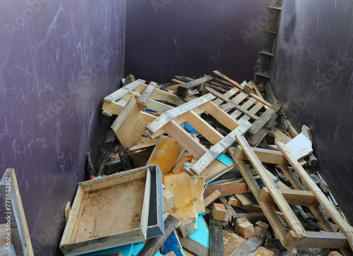 Inside a recycling center container with wooden pieces and scrap lumber for separate waste collection photo