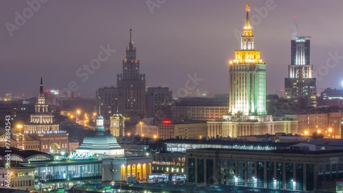 Evening close up view of Stalin skyscrapers and three railway stations day to night transition timelapse at the Komsomolskaya square in Moscow, Russia. Aerial view from rooftop. photo