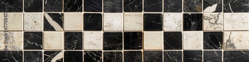 A seamless pattern of black and white marble squares. 