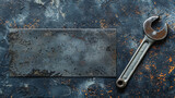 Old wrench on a rustic metallic surface.