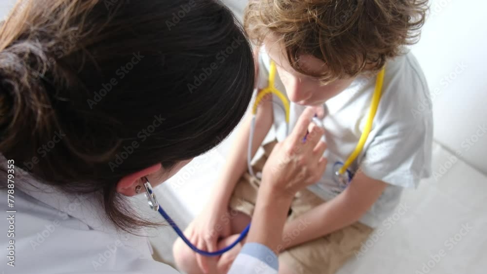 A pediatrician and nurse examine a toddler at the hospital, using a stethoscope to diagnose lung issues, fostering trust and togetherness in healthcare. A pediatrician and nurse examine a toddler at the hospital, using a stethoscope to diagnose lung issues, fostering trust and togetherness in healthcare.
